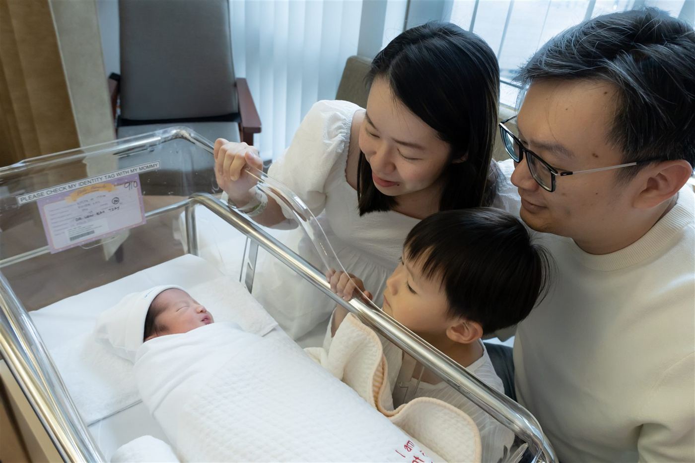 A family meeting their newborn in the hospital